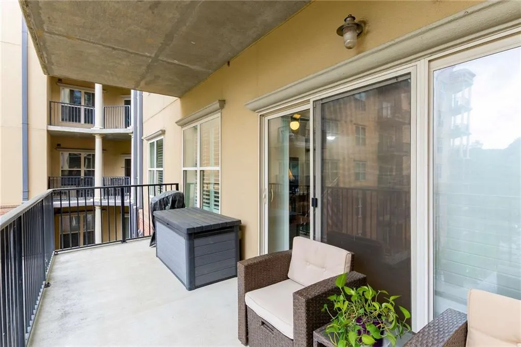 This covered balcony is an extension of your living space. Plenty of room for a table + chairs and a chaise lounger.