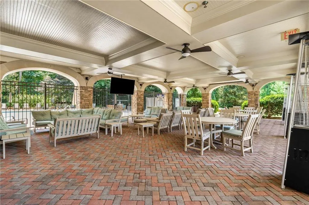 Covered patio with built in televisions provides the perfect place to gather and get out of the sun on a hot day.
