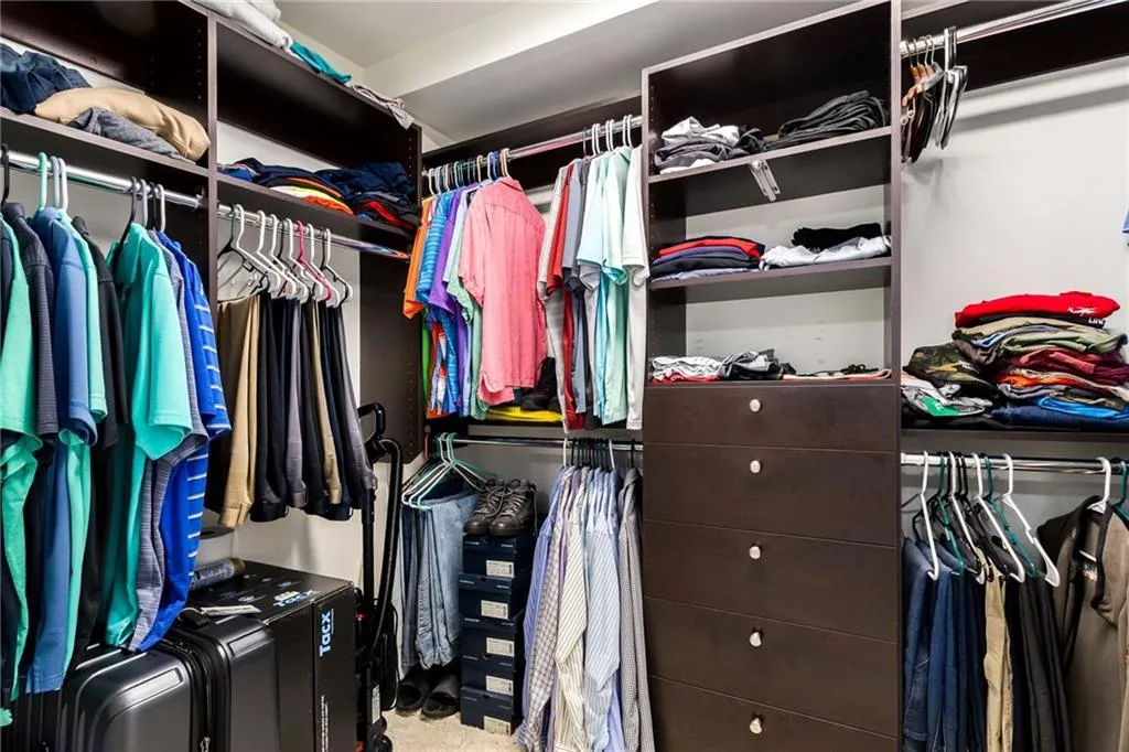 View of spacious closet- all built in shelving unit stays.