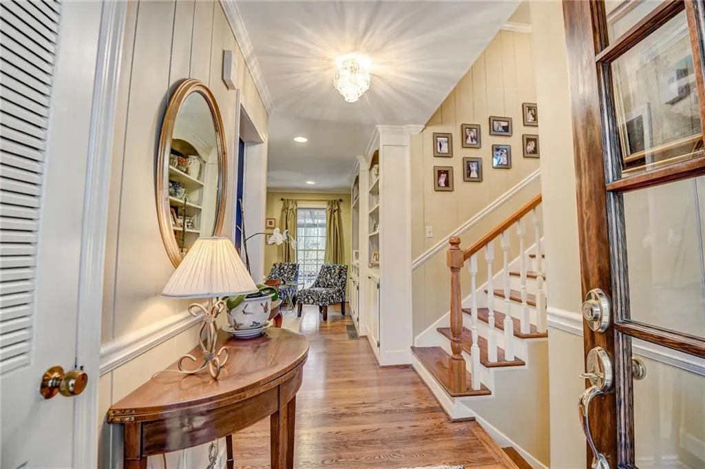 Entrance foyer with crown molding and hardwood / wood-style floors
