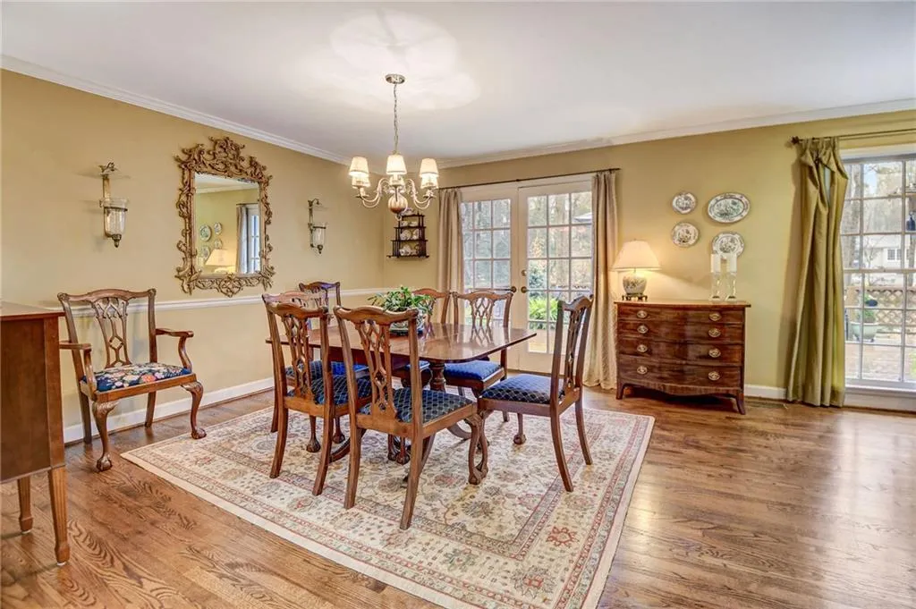 Dining area featuring hardwood / wood-style flooring, an inviting chandelier, plenty of natural light, and french doors