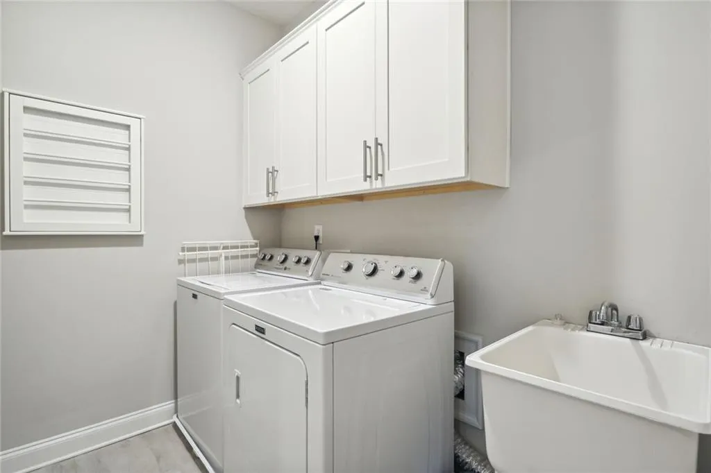 Laundry room with utility sink and drying rack