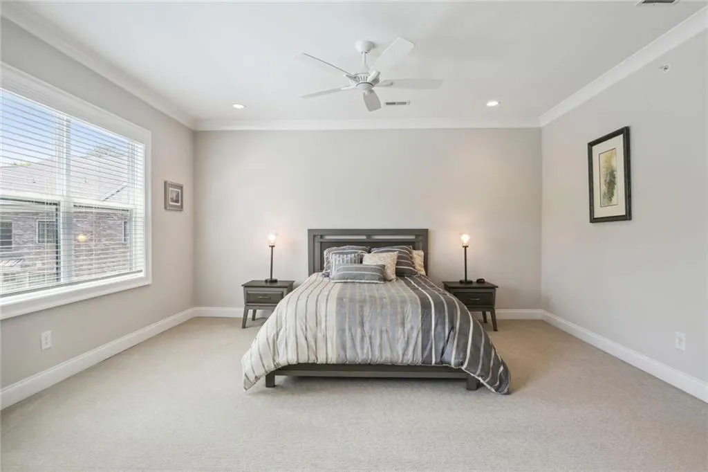 Expansive master bedroom offers views to landscaped pond