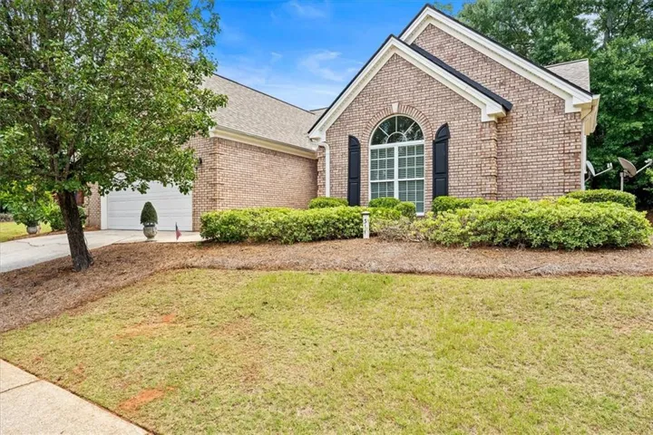 Brick exterior with gabled roofline and arched window