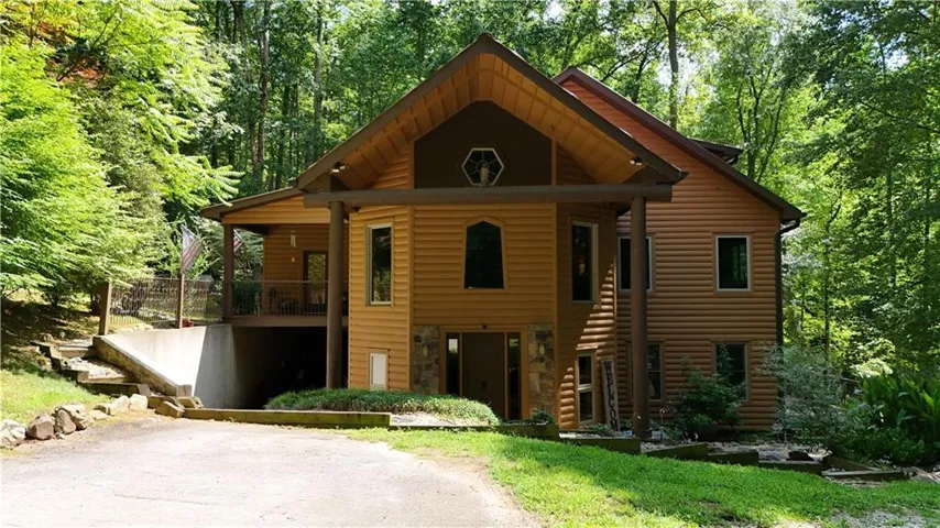 Wood-sided dwelling featuring a covered front entry and a multi-level design