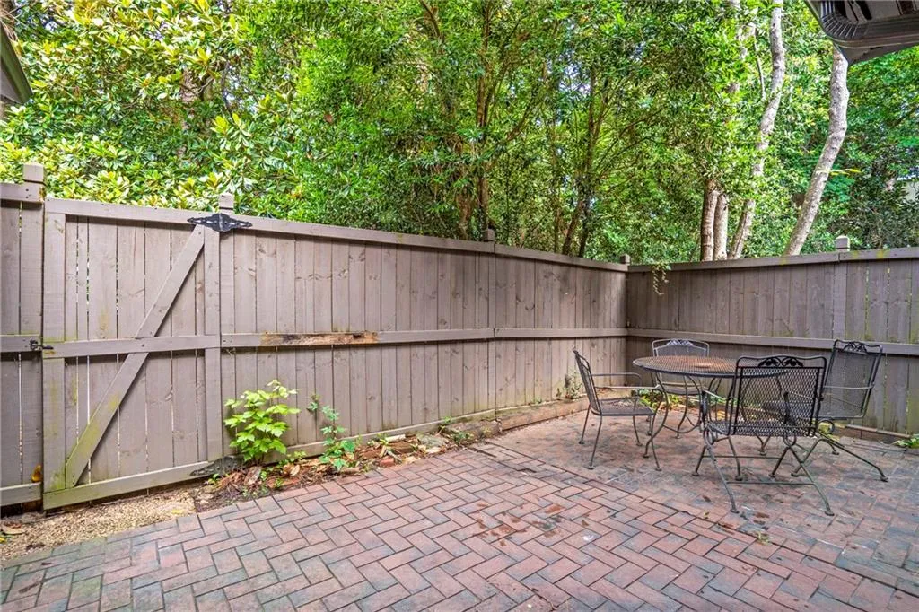Fenced backyard featuring a patio area, a gate, and outdoor dining area
