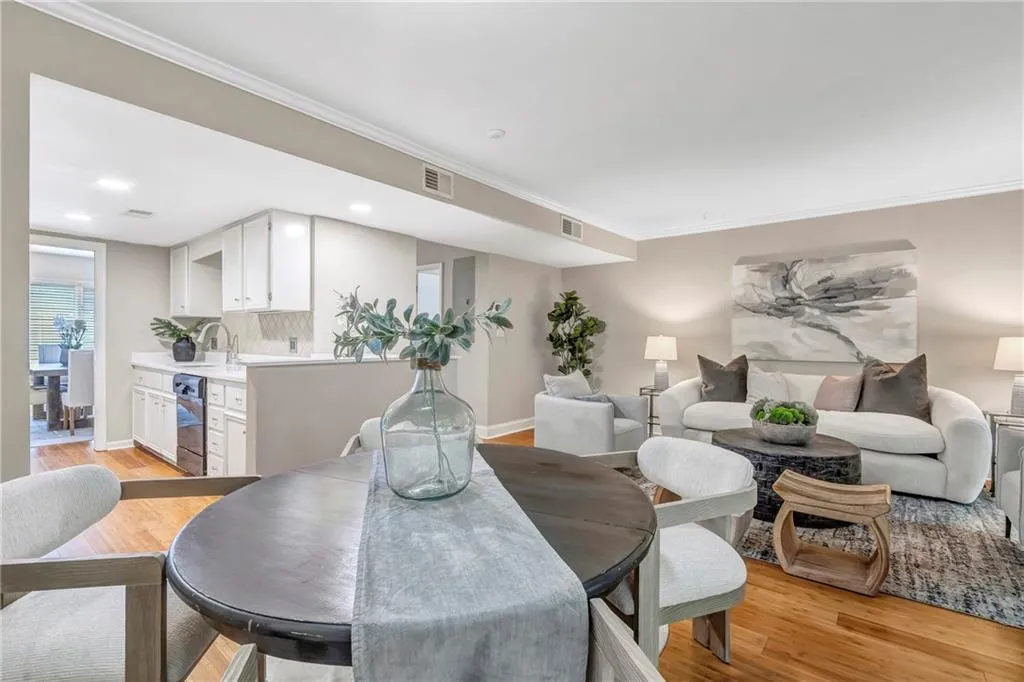 Dining space with ornamental molding, light wood-type flooring, and recessed lighting