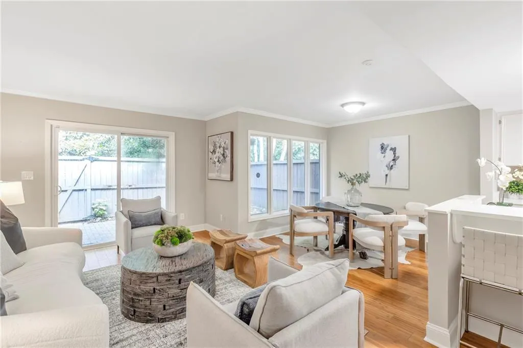 Living room featuring light wood-type flooring and ornamental molding