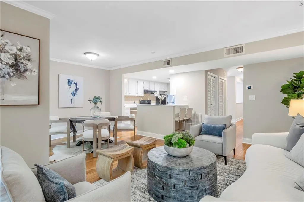 Living room featuring light wood-style floors and ornamental molding
