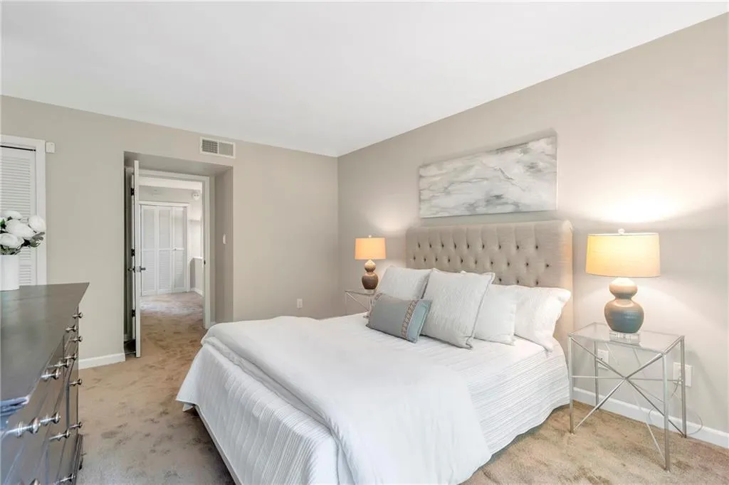 Bedroom with light carpet and baseboards