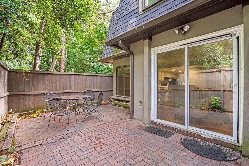 Fenced backyard with a patio area and outdoor dining space