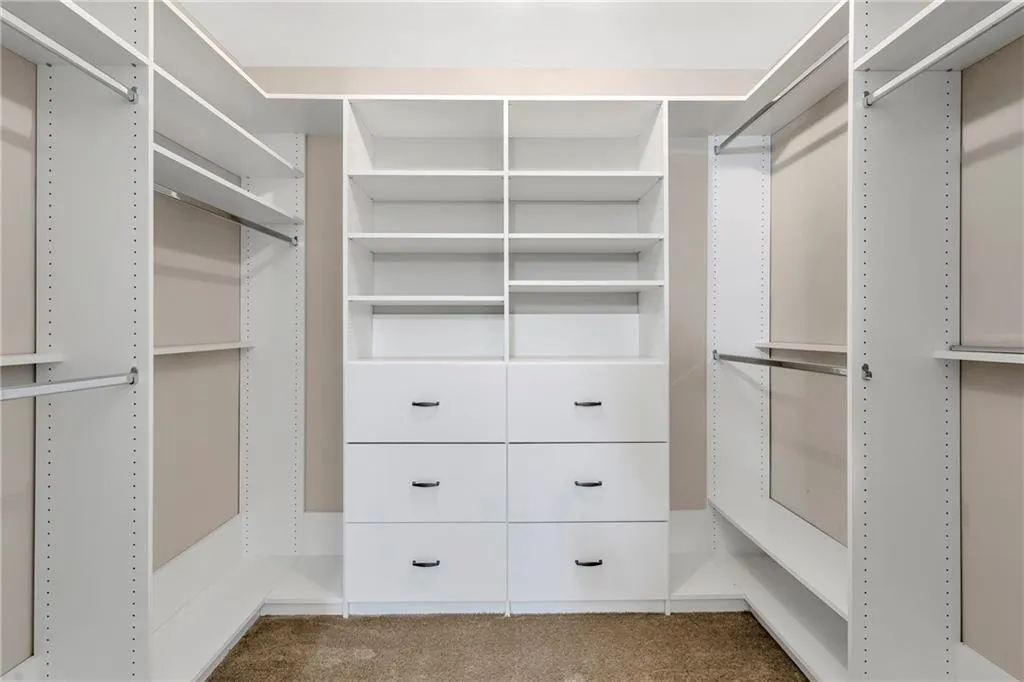 Walk in closet featuring carpet flooring
