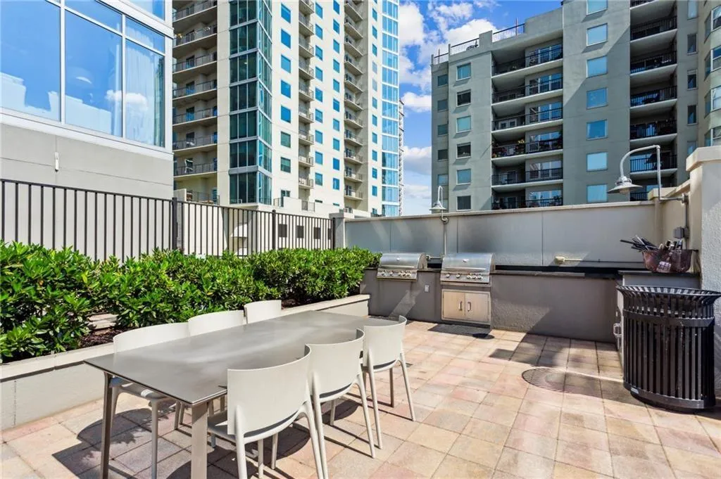 View of patio featuring area for grilling, outdoor dining space, and exterior kitchen