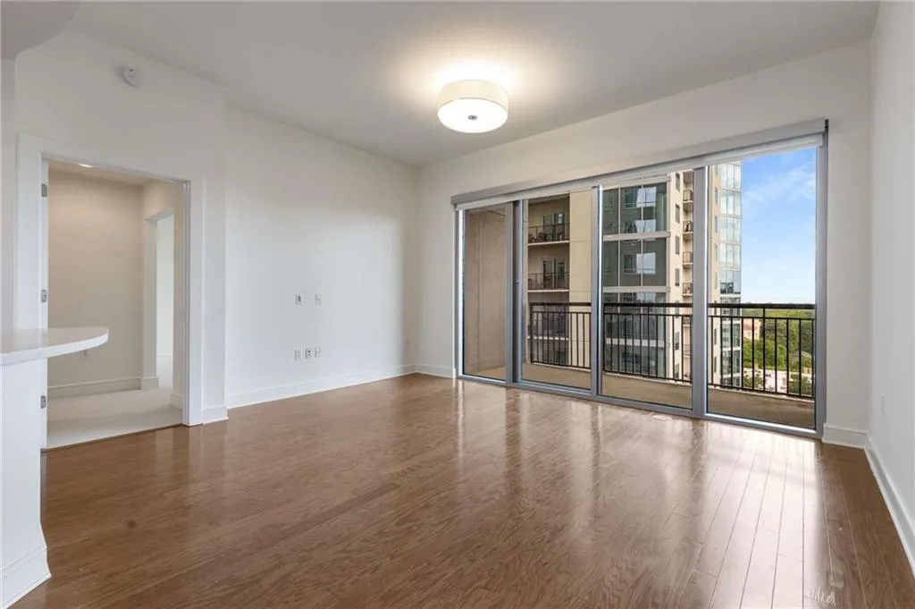 Spare room with baseboards and wood finished floors