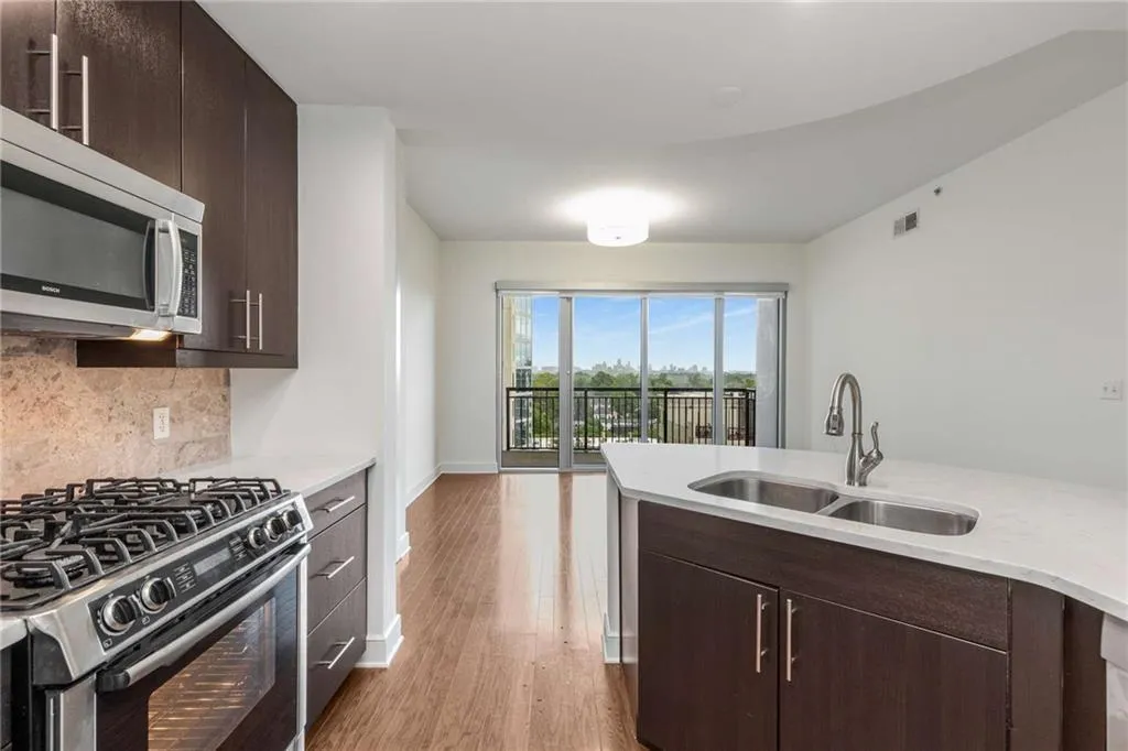 Kitchen featuring a sink, visible vents, light wood-style flooring, light countertops, and appliances with stainless steel finishes