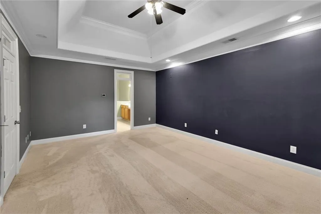 Tray ceiling with recessed lighting and crown molding