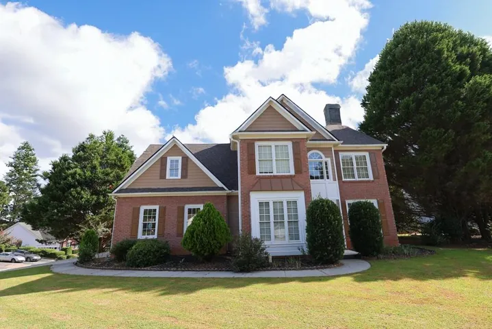 Brick exterior with contrasting siding and white trim