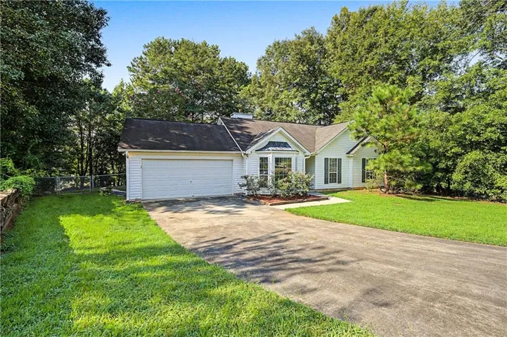 White siding exterior with a dark-shingled roof
