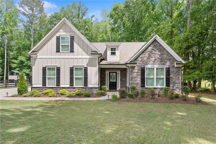 Craftsman-style exterior featuring board and batten siding and stone accents