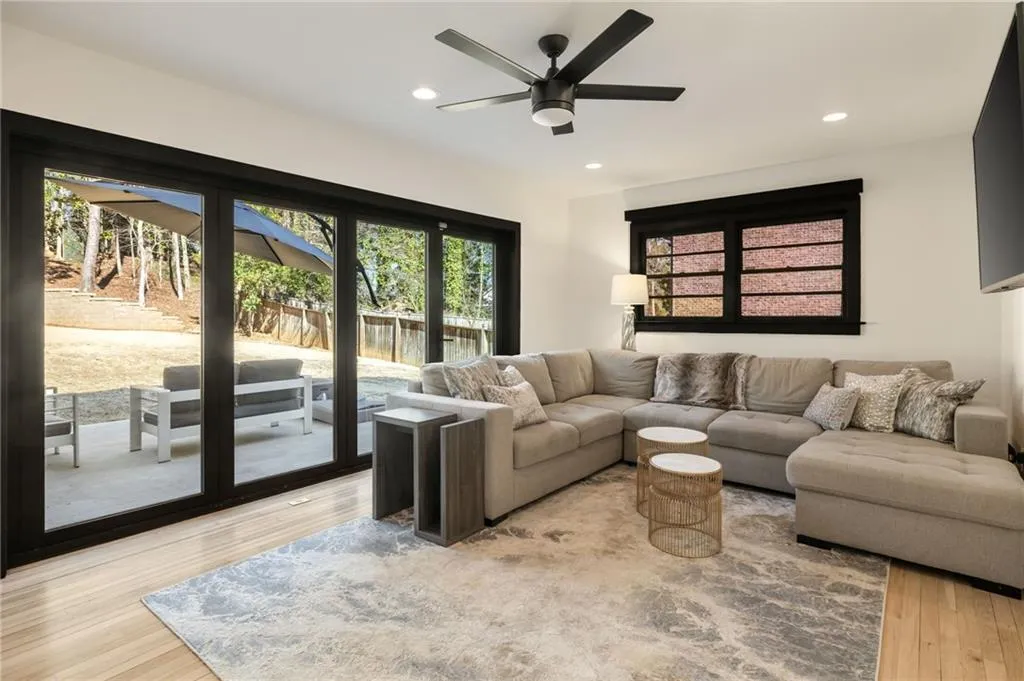 Wood-finish flooring, recessed lighting, and a dark-toned ceiling fan with integrated light