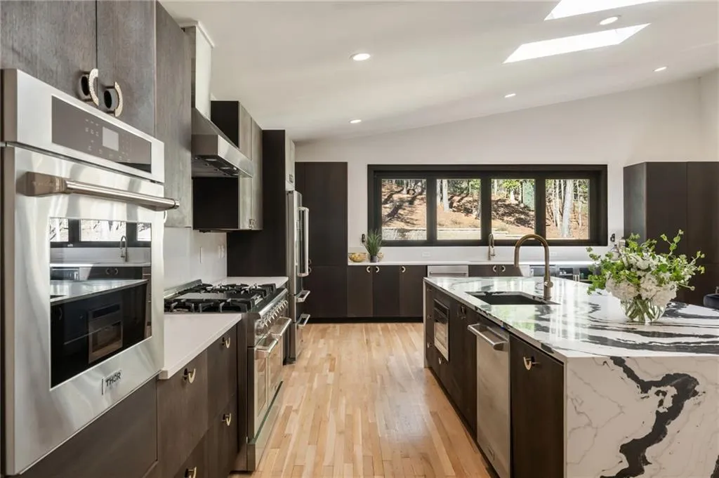 Modern kitchen featuring wood-finish flooring and dark wood-finish cabinetry