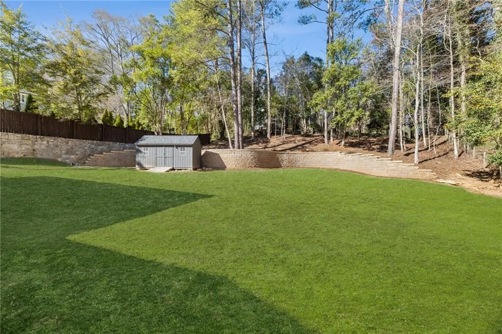 Expansive manicured lawn with tiered retaining walls