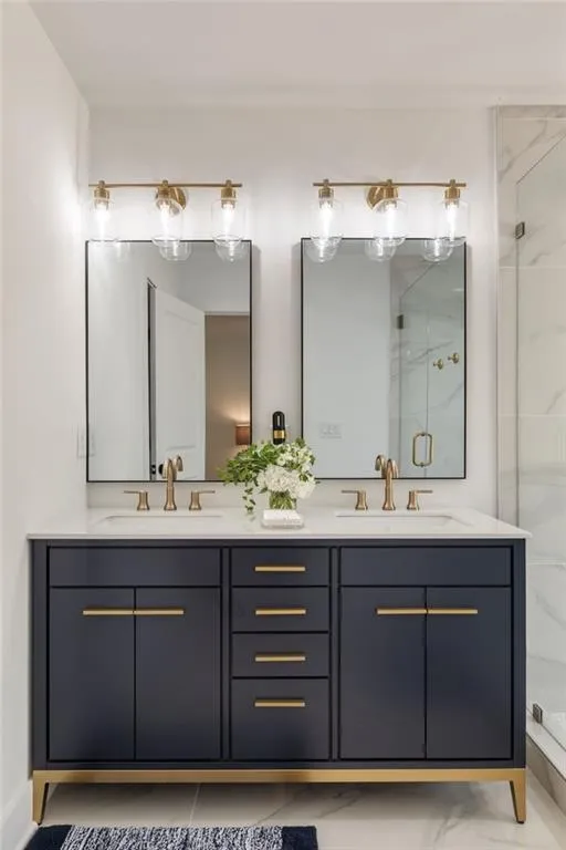 Dual vanity with a white countertop, two undermount sinks, and gold-finish faucets