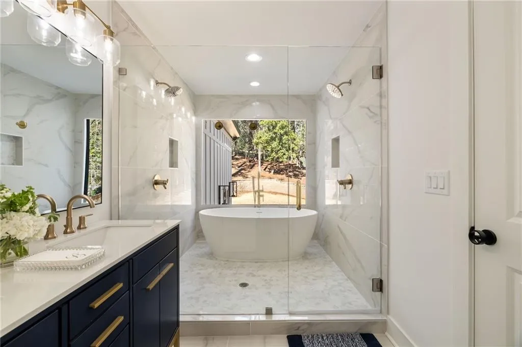 Freestanding soaking tub with gold-tone fixtures