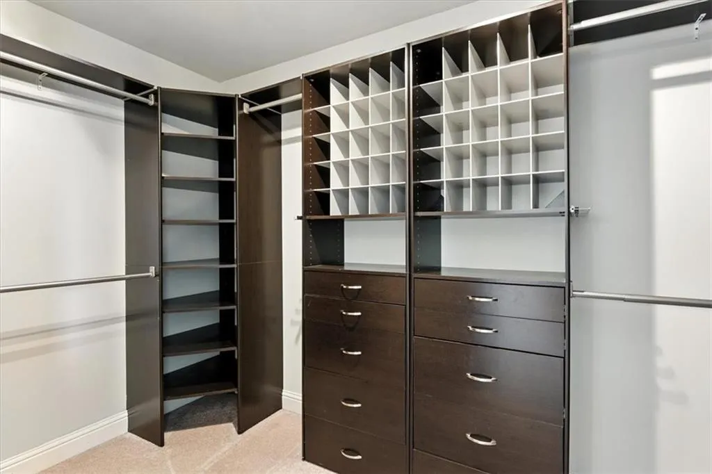 Walk in closet with light carpet
