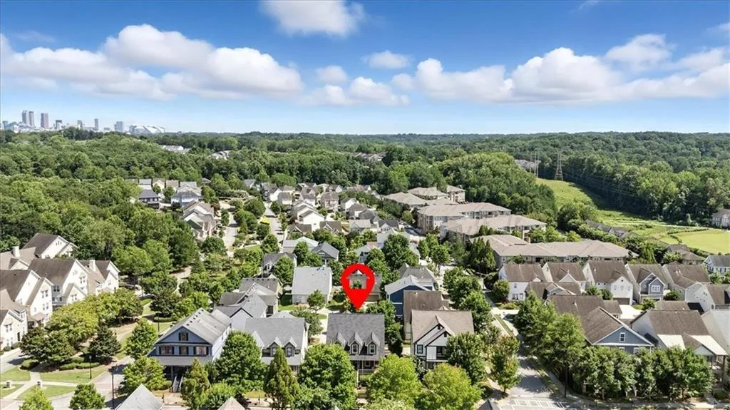 Aerial perspective of suburban area featuring a heavily wooded area