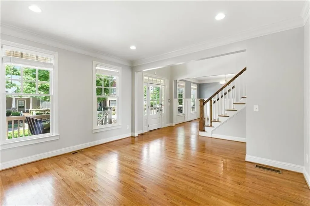 Entrance foyer with crown molding, light wood-type flooring, stairway, and recessed lighting