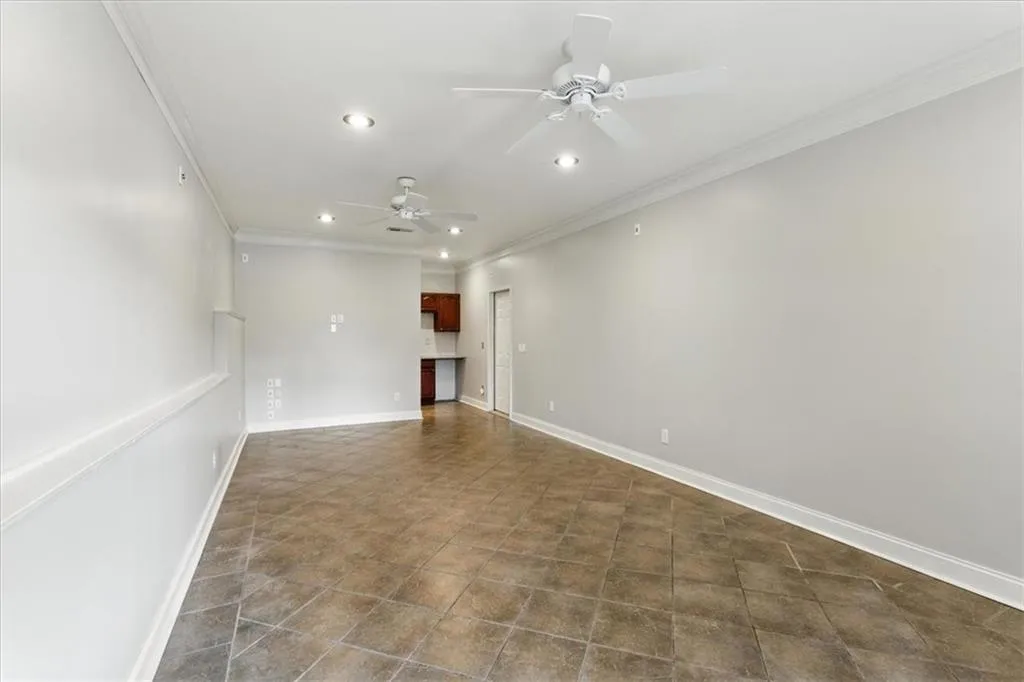 Spare room with crown molding, recessed lighting, and a ceiling fan