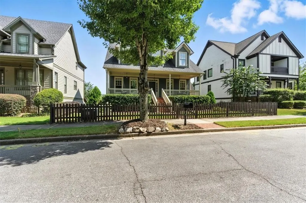 View of front facade with covered porch and a fenced front yard