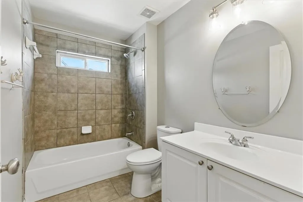 Bathroom featuring vanity,  shower combination, and tile patterned floors