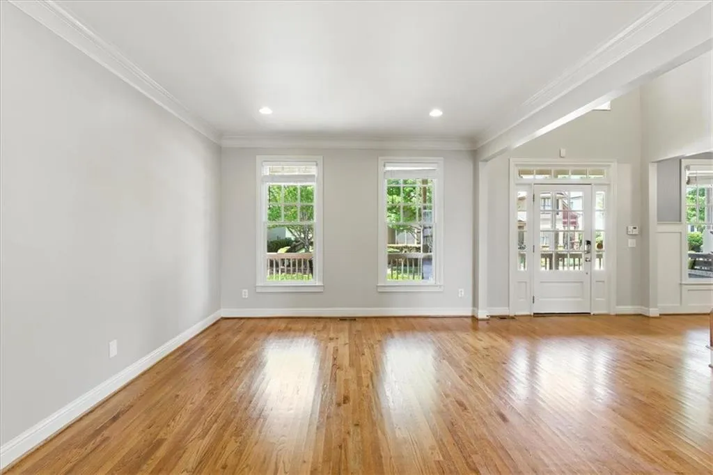 Unfurnished room with ornamental molding, wood finished floors, and recessed lighting