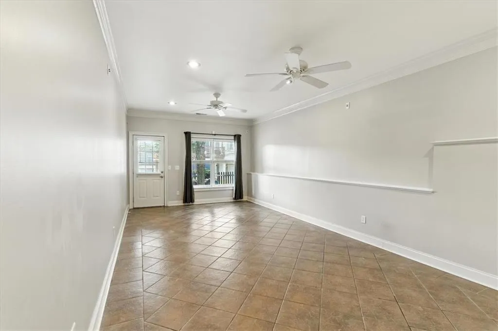 Spare room with crown molding, tile patterned floors, recessed lighting, and ceiling fan