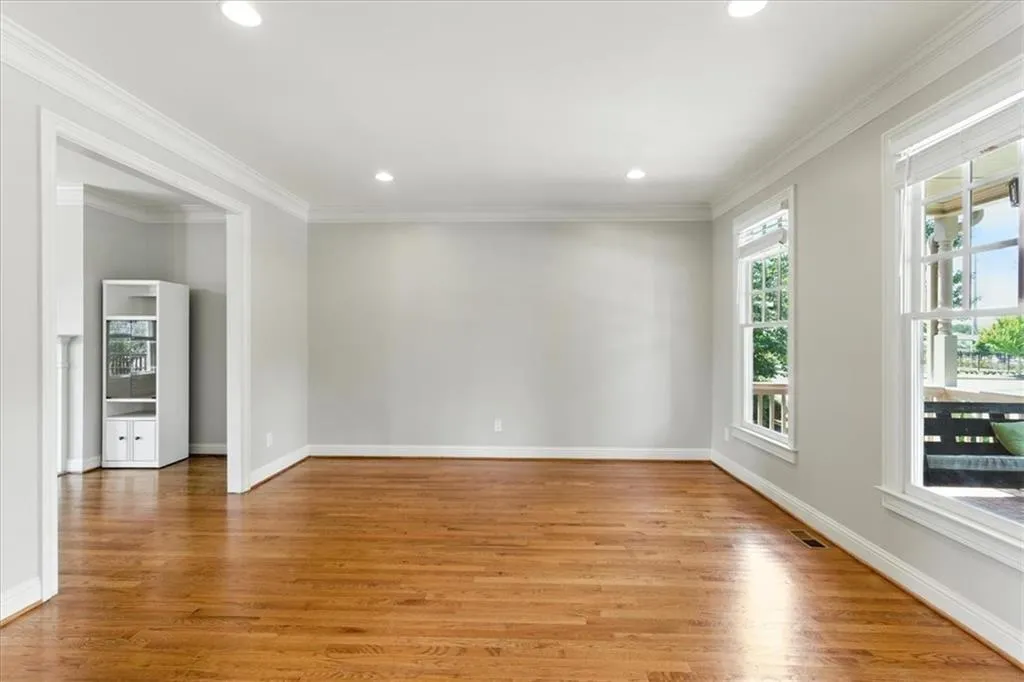 Spare room with ornamental molding, light wood-style floors, and recessed lighting