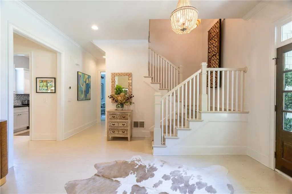 Entrance foyer featuring a chandelier and crown molding