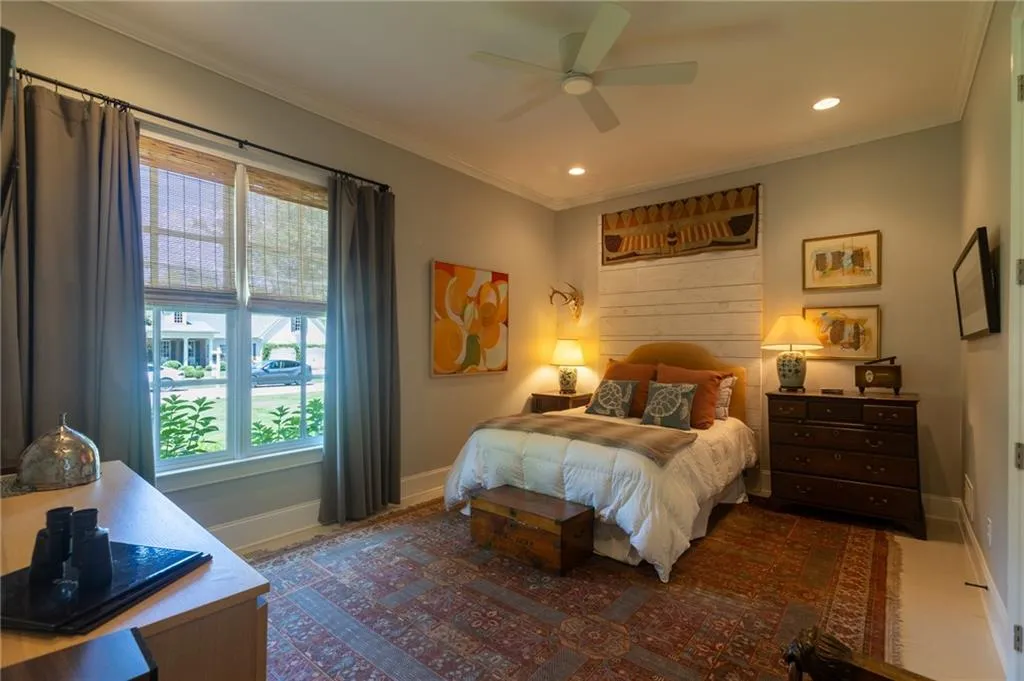 Bedroom featuring ceiling fan and crown molding