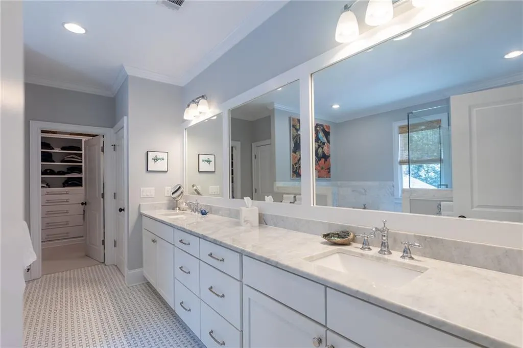 Bathroom with tile floors, crown molding, and dual bowl vanity