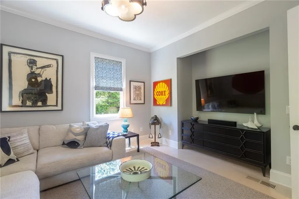 Living room featuring ornamental molding and carpet floors