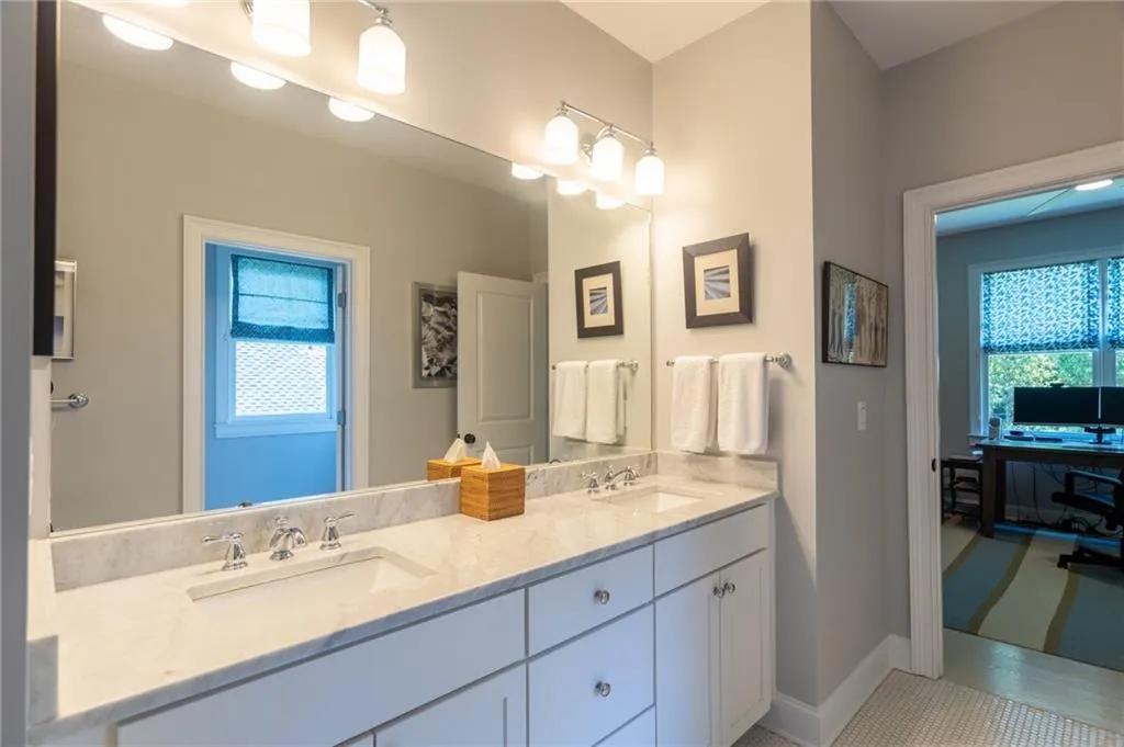 Bathroom with tile flooring, oversized vanity, and dual sinks