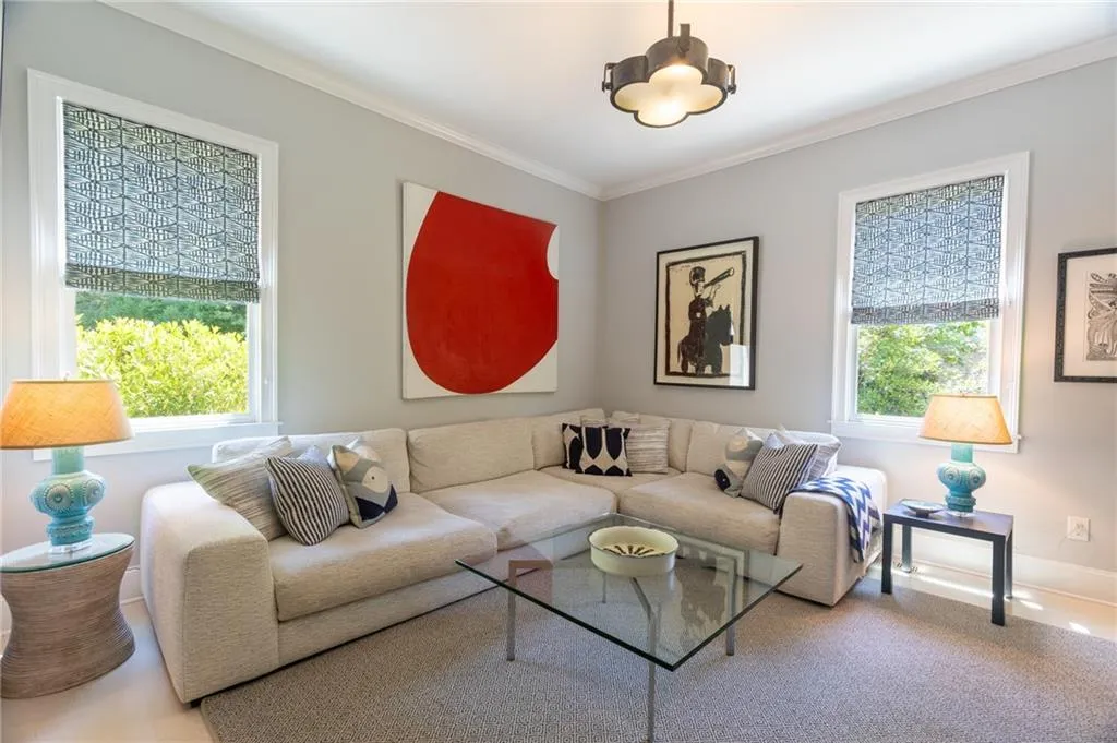 Carpeted living room with a healthy amount of sunlight and ornamental molding