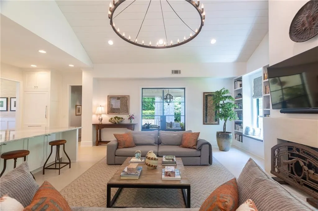 Living room featuring a notable chandelier and vaulted ceiling