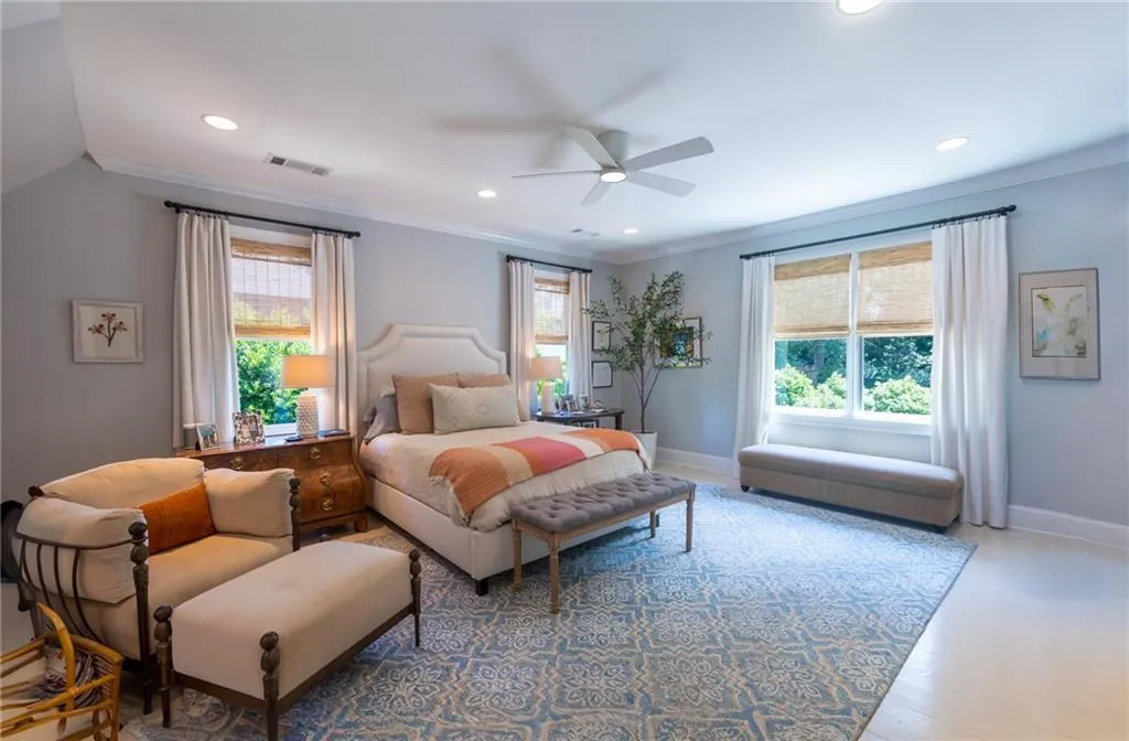 Bedroom featuring hardwood / wood-style flooring, ceiling fan, and crown molding