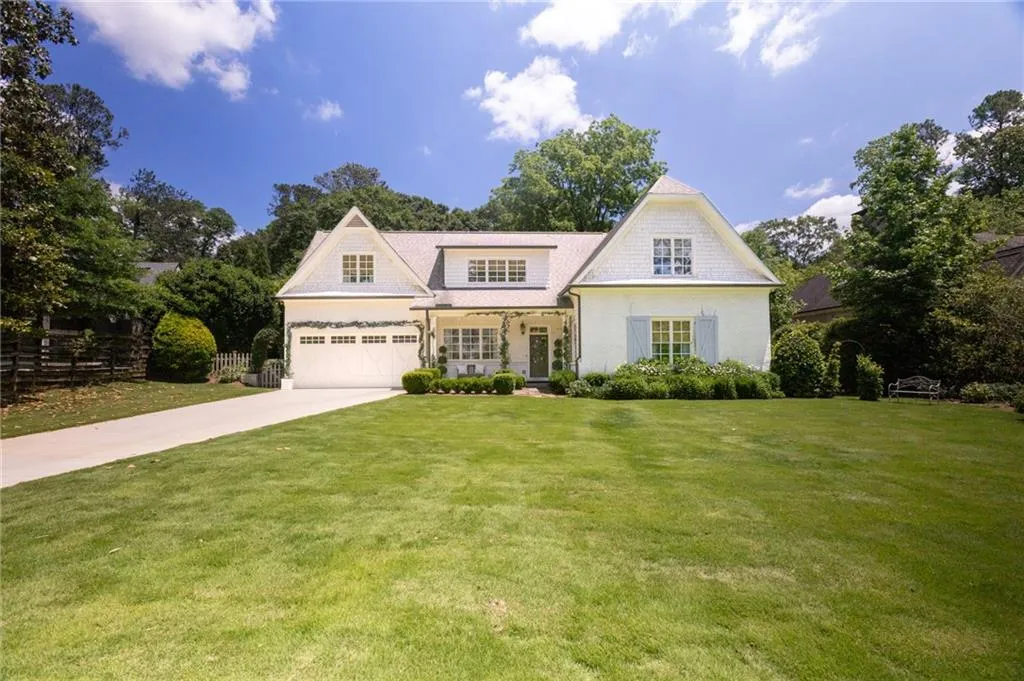 View of front facade with a garage and a front lawn