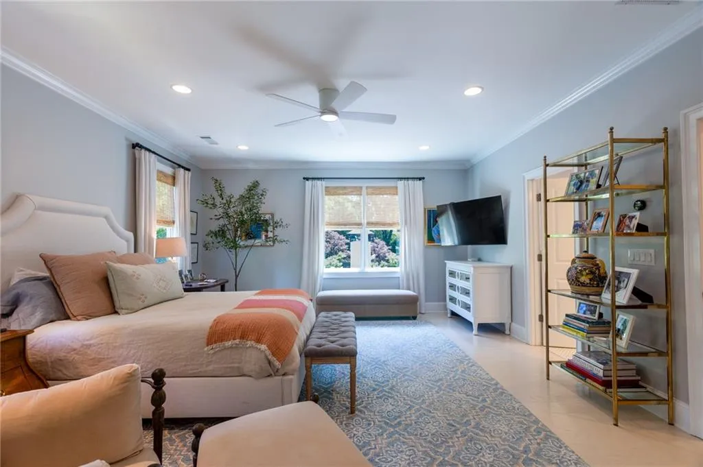 Bedroom with ornamental molding and ceiling fan
