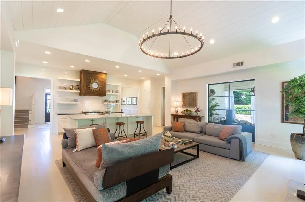 Living room with a notable chandelier and high vaulted ceiling