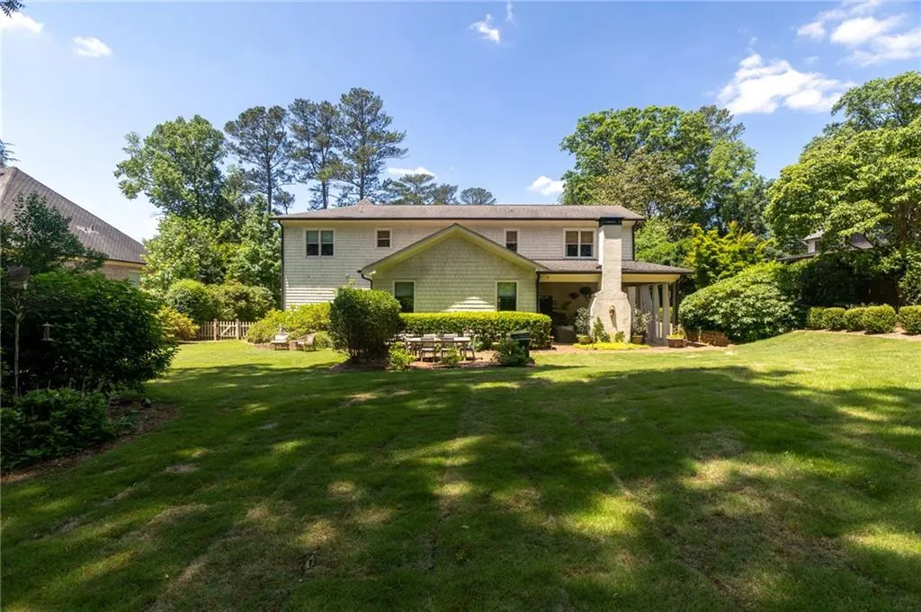 Rear view of house featuring a yard