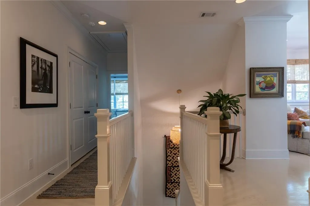 Corridor featuring crown molding
